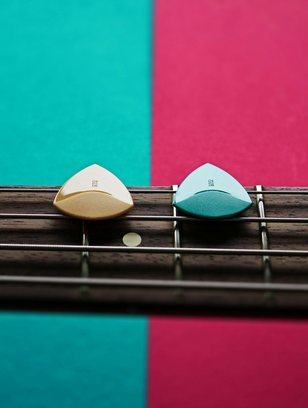 a-close-up-of-a-guitar-fret-with-a-guitar-pick-fan-ndj-fb8