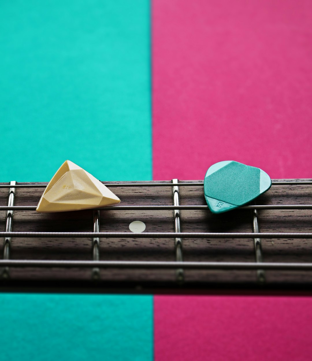 a-close-up-of-a-guitar-string-with-a-paper-boat-on-top-of-it-hwoyt9qr4lo