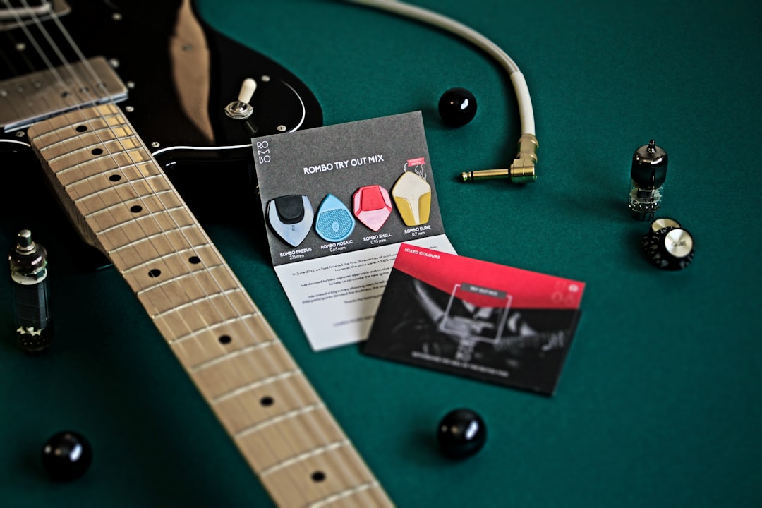 a-guitar-with-a-guitar-tuner-and-a-card-rvgffplpnhe