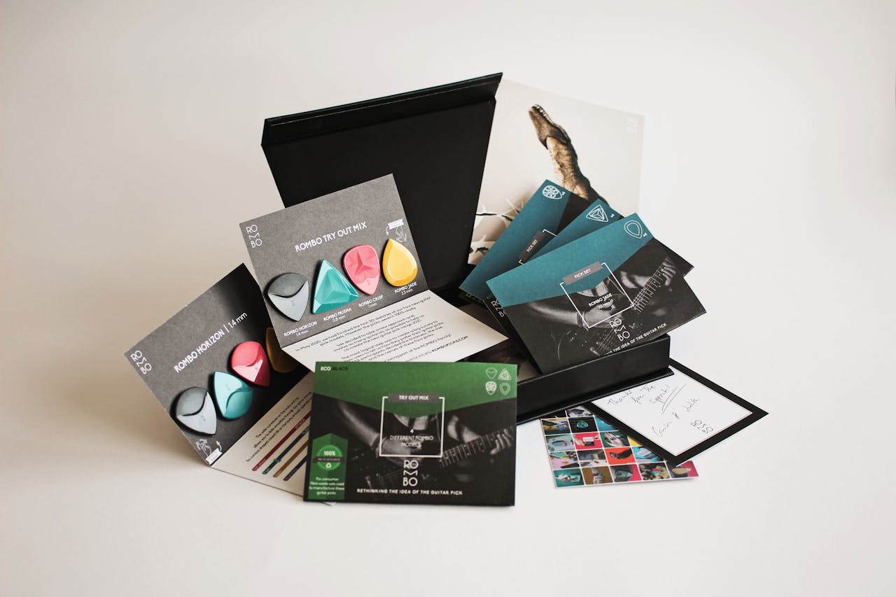 Creative display of vibrant guitar picks and packaging in a minimalist setup.
